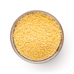 Fresh organic millet in bowl, Top view.