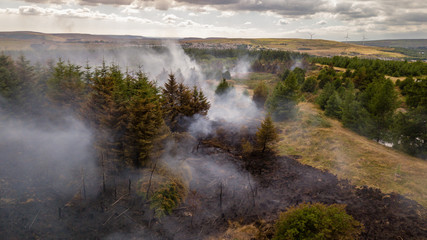 Aerial drone view of a smouldering wildfire in Wales, UK