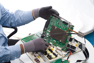 Man handling electronic circuit board