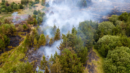 Aerial drone view of a smouldering wildfire in Wales, UK
