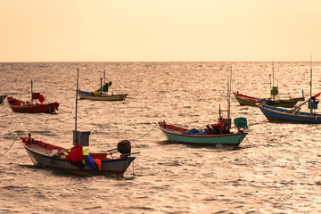 Naklejka na ściany i meble Floating fishing boats aground at the harbor in the sea sunset time at Chanthaburi, Thailand.