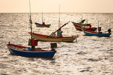 Naklejka na ściany i meble Floating fishing boats aground at the harbor in the sea sunset time at Chanthaburi, Thailand.