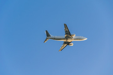 white plane flying in the blue sky