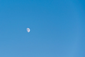 half moon in the blue sky