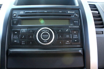Management of the music system on the dashboard of the car. Interior view of the car interior.