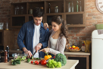 Happy couple cooking dinner together