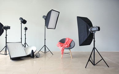 Modern chair in photo studio with professional equipment