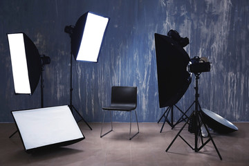 Modern chair in photo studio with professional equipment