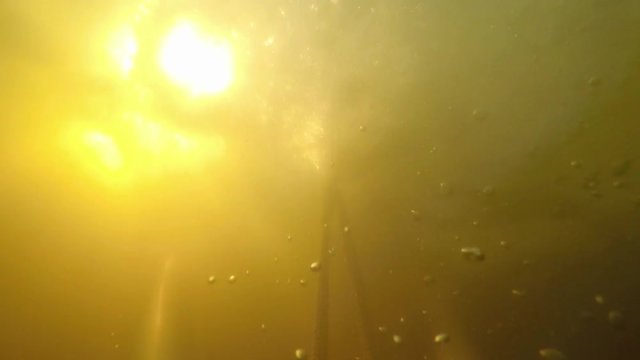 Sun rays under water. Slow Motion