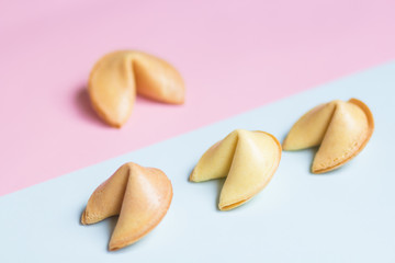fortune cookie on pink and blue background, pastel colors