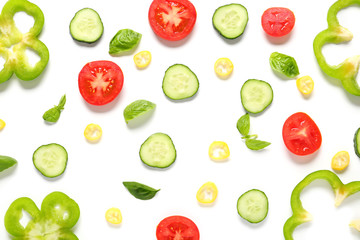 Fresh sliced vegetables with basil on white background
