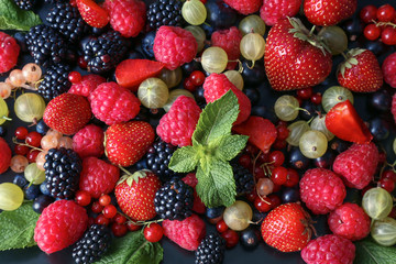 Delicious ripe berries on plate, closeup