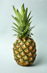 Ripe pineapple on light background