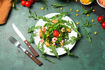 Plate with tasty shrimp salad on table