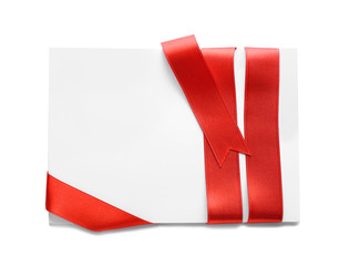 Blank paper card with red ribbon on white background