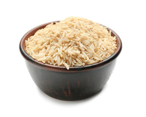 Bowl with brown rice on white background