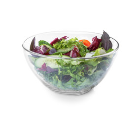 Glass bowl with fresh vegetable salad on white background