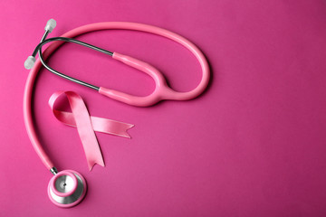Pink ribbon and stethoscope on color background. Breast cancer awareness concept