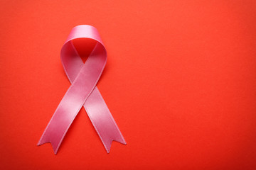 Pink ribbon on color background. Breast cancer awareness concept
