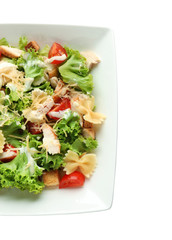 Tasty Caesar salad with pasta on white background