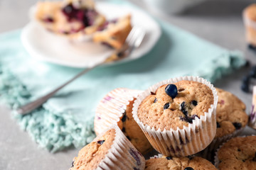 Tasty blueberry muffins on grey table, closeup