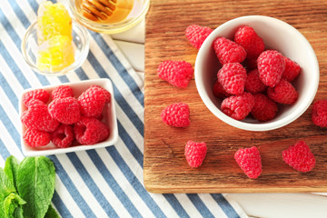 Delicious fresh ripe raspberries on table