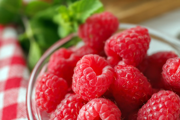 Bowl with delicious fresh ripe raspberries, closeup