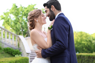 Naklejka premium Happy young bride with her groom outdoors