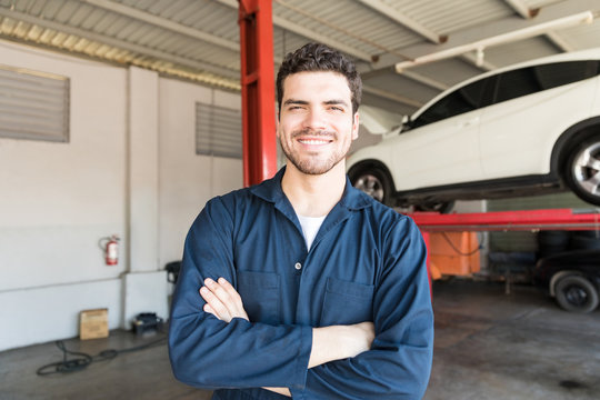 Smiling Worker Standing Arms Crossed In Auto Repair Shop
