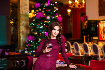 The girl at restaurant with a champagne glass for new year