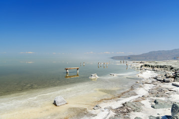 Wooden pillars with crystallized salt on Urmia Salt Lake. Iran