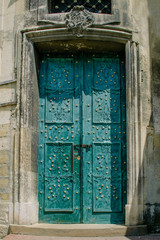 Europe, Ukraine, Lviv. Ancient wooden door of green color. Vintage, retro. Travel.