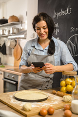 Checking online recipe for sweet berry pie