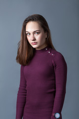 Portrait of happy nice schoolgirl teenager on gray background