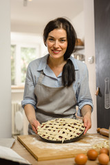 Woman holding sweet pie in her hands