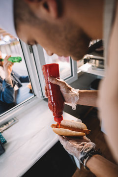 Chef preparing hot dog in food truck