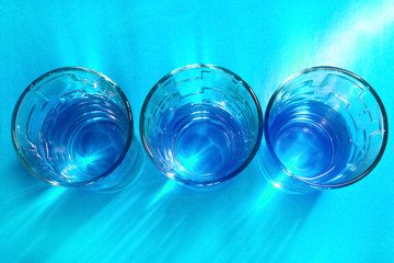 glasses with water on a colored background