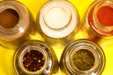 spices in a glass jar on a colored background