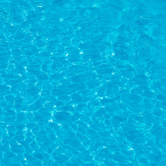 Background. Blue water with sunlight in the pool in the open air. view from above
