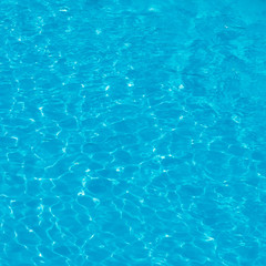 Background. Blue water with sunlight in the pool in the open air. view from above