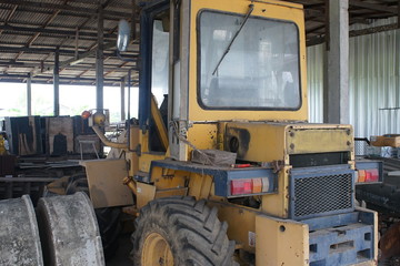 Old tractor plowing in garage.