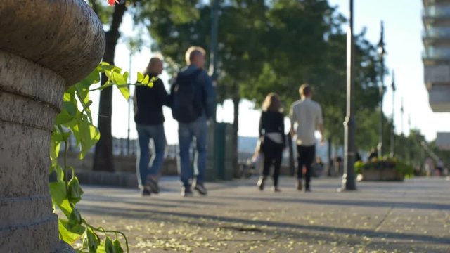 People in the city walking in the sunny afternoon.