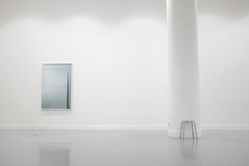 Empty white art gallery with a art piece and a chair