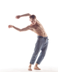 Young beautiful dancer is posing in studio