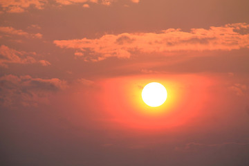 orange sun in the lilac sky during the sunset