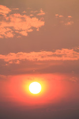 orange sun in the lilac sky during the sunset