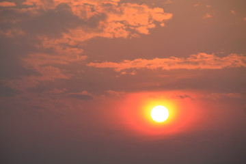 orange sun in the lilac sky during the sunset