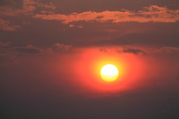 orange sun in the lilac sky during the sunset