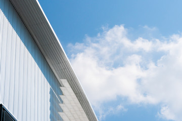 Factory Warehouse roof with cloudy blue sky