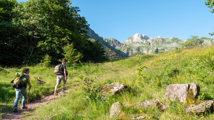 Fototapeta na wymiar Two hikers walking in Pyrenees mountains